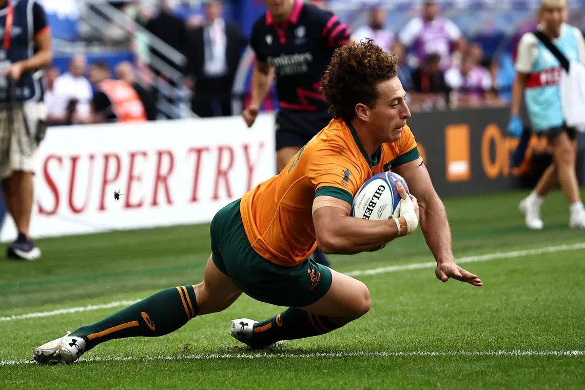 Australia's Mark Nawaqanitawase dives and scores a try  during the Rugby World Cup match against Georgia.