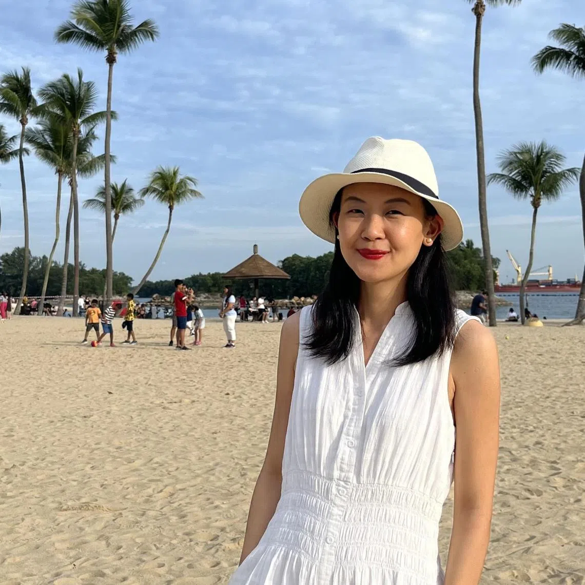 Museum curator Jackie Yoong enjoying the sun on Siloso Beach, Sentosa, in July 2023. 