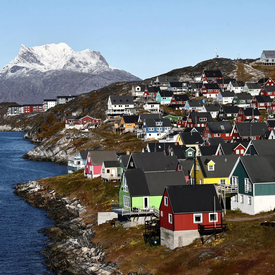 FILE PHOTO: Houses stand in front of the mountain Sermitsiaq, in Nuuk, Greenland, September 19, 2026. REUTERS/Tim Barsoe/File Photo