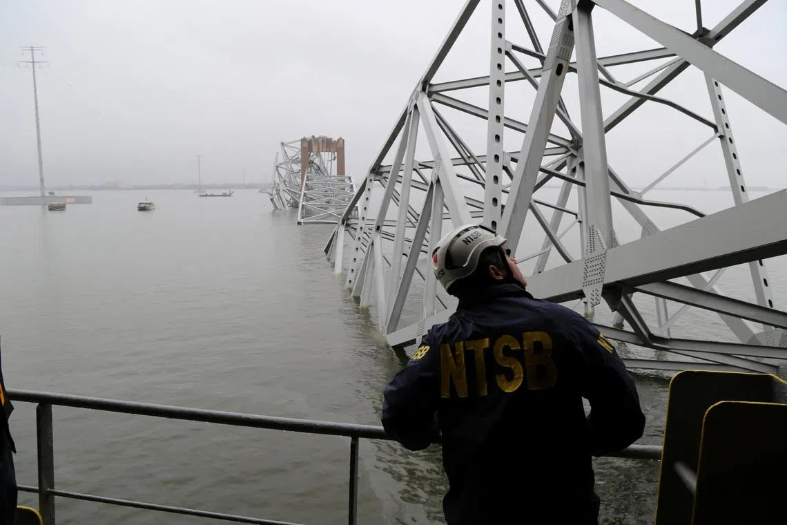 A National Transportation Safety Board (NTSB) worker looks on at the cargo vessel Dali, which struck and collapsed the Francis Scott Key Bridge, in Baltimore, Maryland, U.S. March 27, 2024. Peter Knudson/NTSB/Handout via REUTERS    THIS IMAGE HAS BEEN SUPPLIED BY A THIRD PARTY