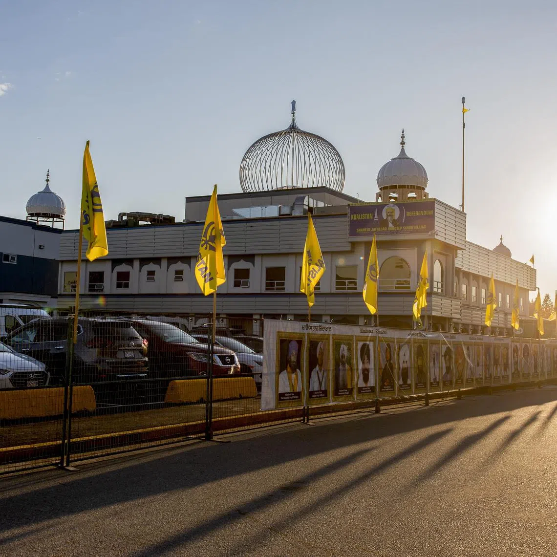 FILE — Flags of the Khalistan separatist movement flank the Guru Nanak Sikh Gurdwara, where Hardeep Singh Nijjar was shot and killed in the parking lot in June, in Surrey, British Columbia, Canada, on Sept. 20, 2023. Prime Minister Justin Trudeau’s top aides spoke at a public hearing a day after Canada accused Indian diplomats of orchestrating killings and extortions in the country. (Jackie Dives /The New York Times)