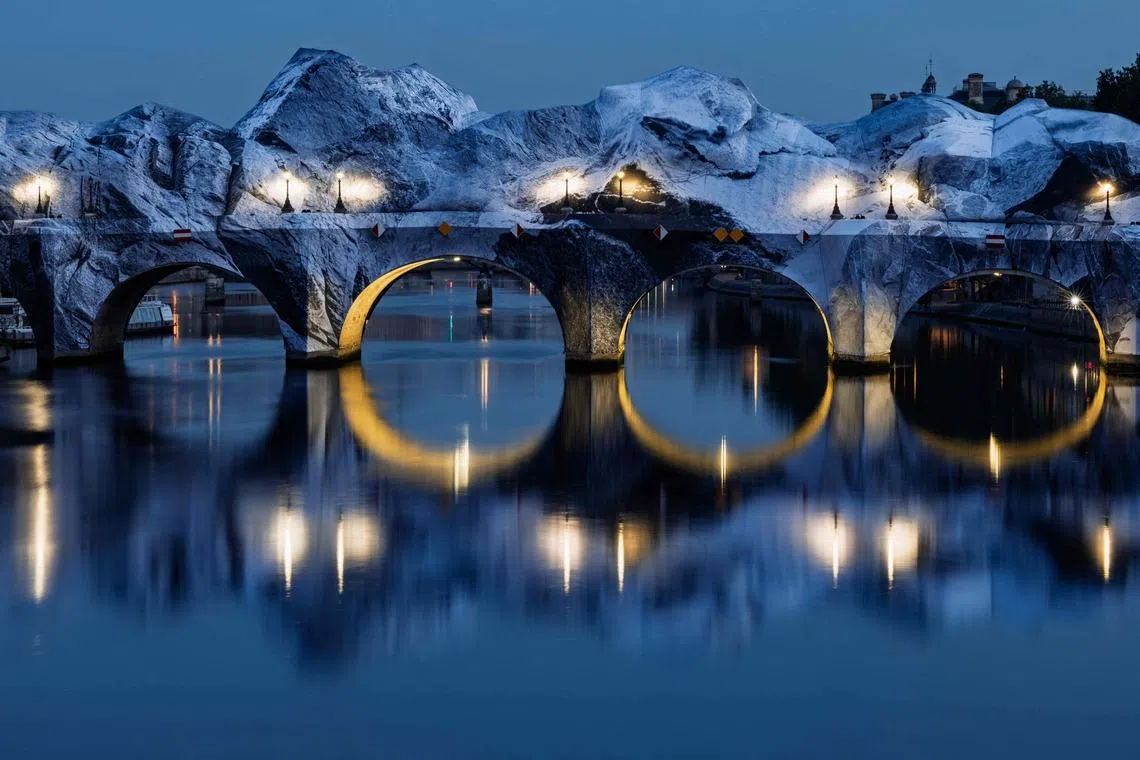 The installation of "The Pont Neuf's cave", the latest artwork by French photographer and street artist JR, on the Pont-Neuf bridge in Paris, on May 28, 2026. 