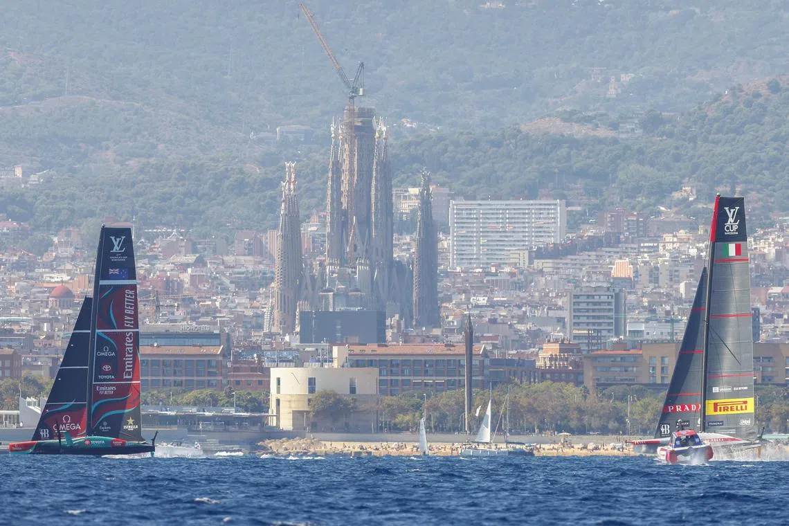 Team New Zealand (left) and team Luna Rossa compete during Round Robin 1 of the 2024 Louis Vuitton Cup sailing competition in Barcelona on Aug 29, 2024.