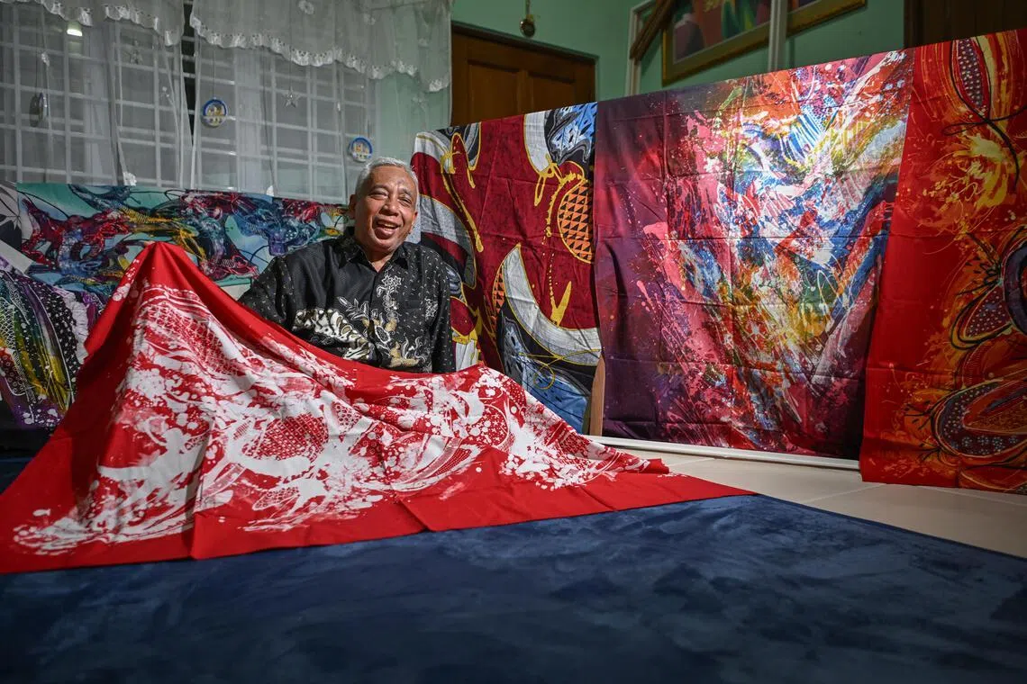Batik artist Ika Zahri Sarkasi, son of the late Sarkasi Said, with his father’s works.