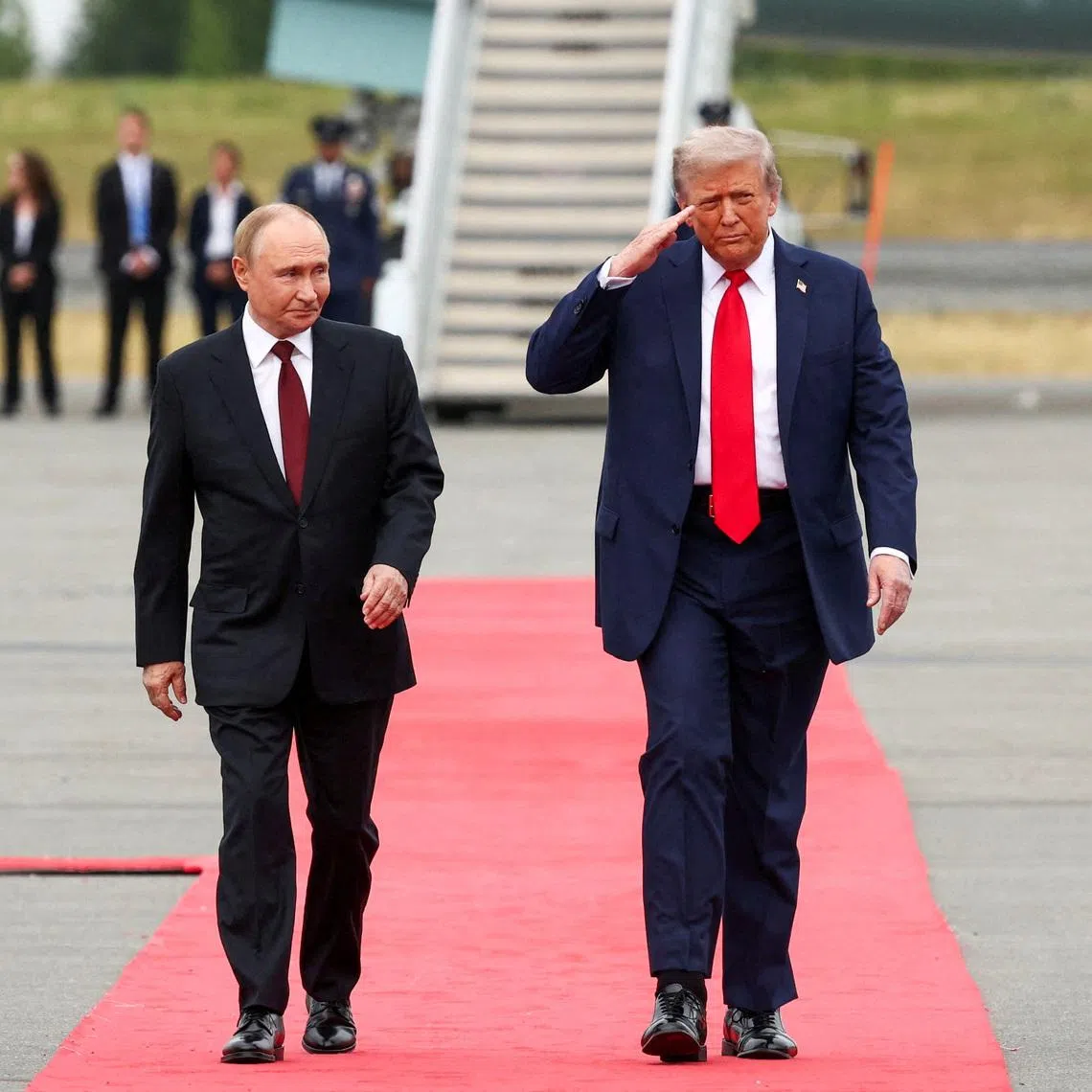 U.S. President Donald Trump walks with Russian President Vladimir Putin, as they meet to negotiate for an end to the war in Ukraine, at Joint Base Elmendorf-Richardson in Anchorage, Alaska, U.S., August 15, 2025. REUTERS/Kevin Lamarque