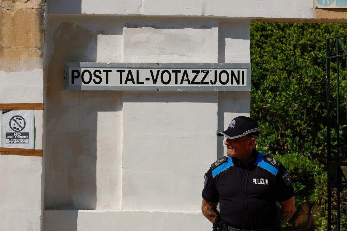 A police officer stands in front of a polling station during Malta's general election, in Zejtun, Malta, May 30, 2026.  REUTERS/Darrin Zammit Lupi