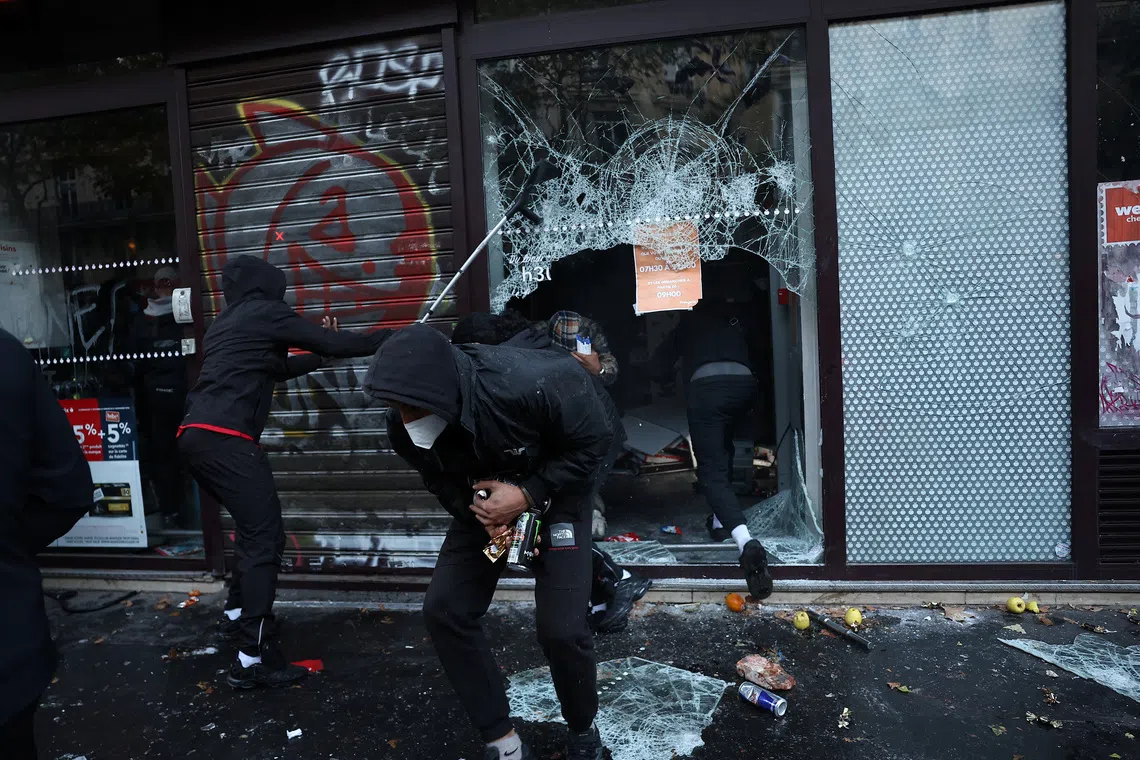 Protesters loot a supermarket amid clashes during a day of demonstrations against the cost of living in France, on Oct 17.