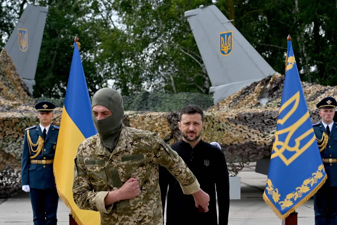 Ukrainian President Volodymyr Zelensky (centre right) presenting awards to Ukrainian servicemen on Aug 4.