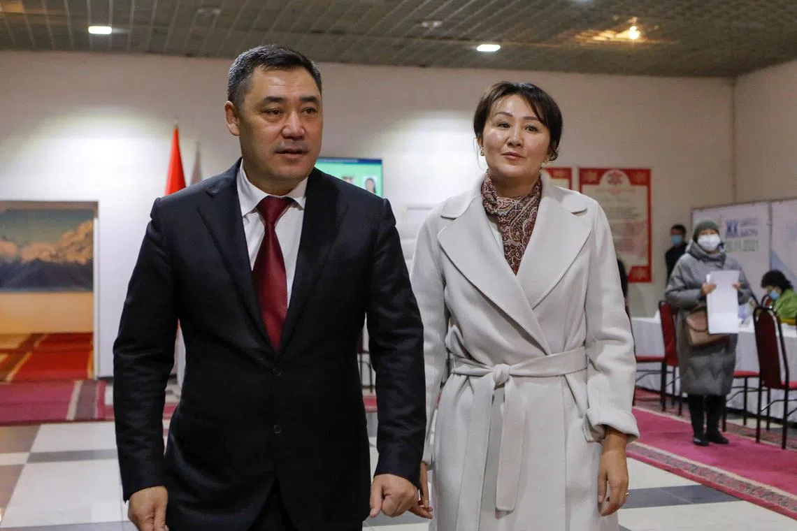 FILE PHOTO: Kyrgyzstan's President Sadyr Japarov and his wife Aigul visit a polling station during the parliamentary election in Bishkek, Kyrgyzstan, November 28, 2021. REUTERS/Vladimir Pirogov/File Photo