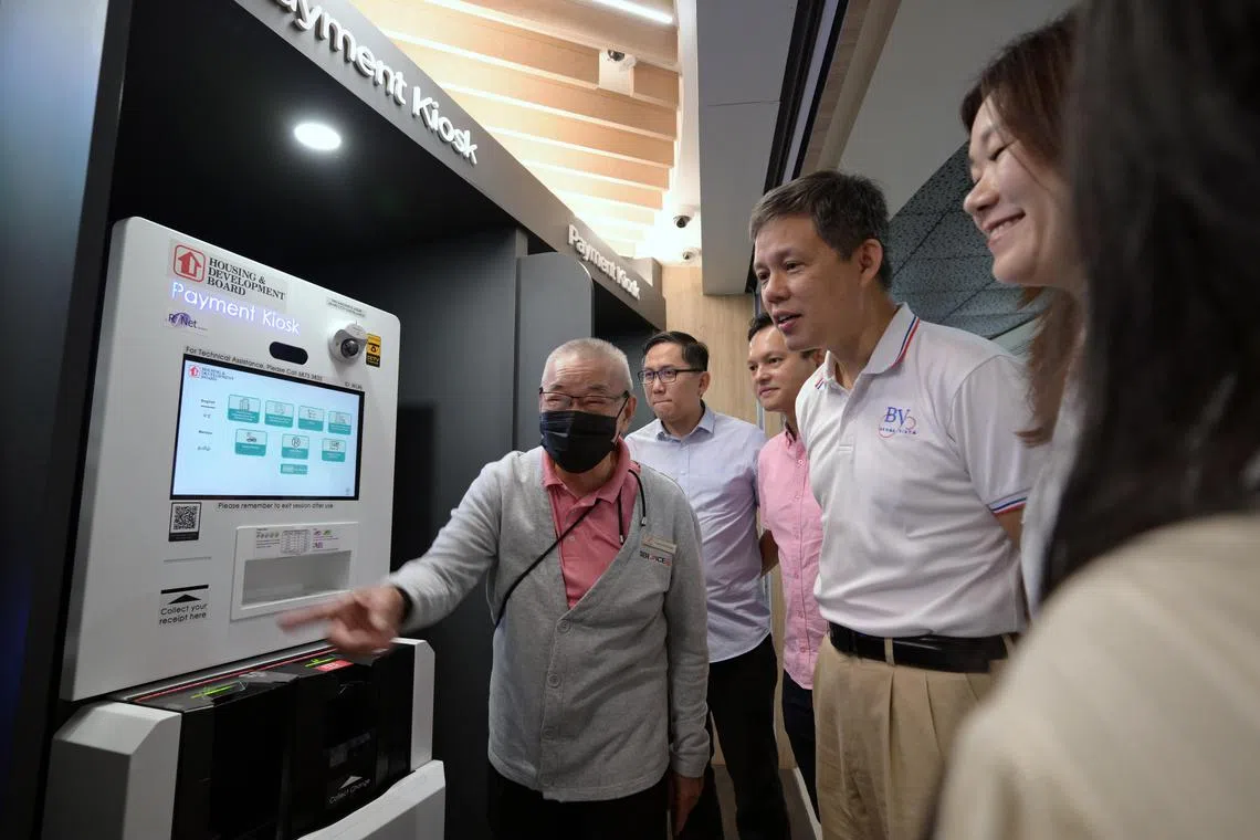 Minister of Education and Minister-in-charge of Public Service Mr. Chan Chun Sing with community kaki, Mr. Fong Kwok Onn, 76, at the new ServiceSG Centre at Woodlands Civic Centre on March 15, 2025.