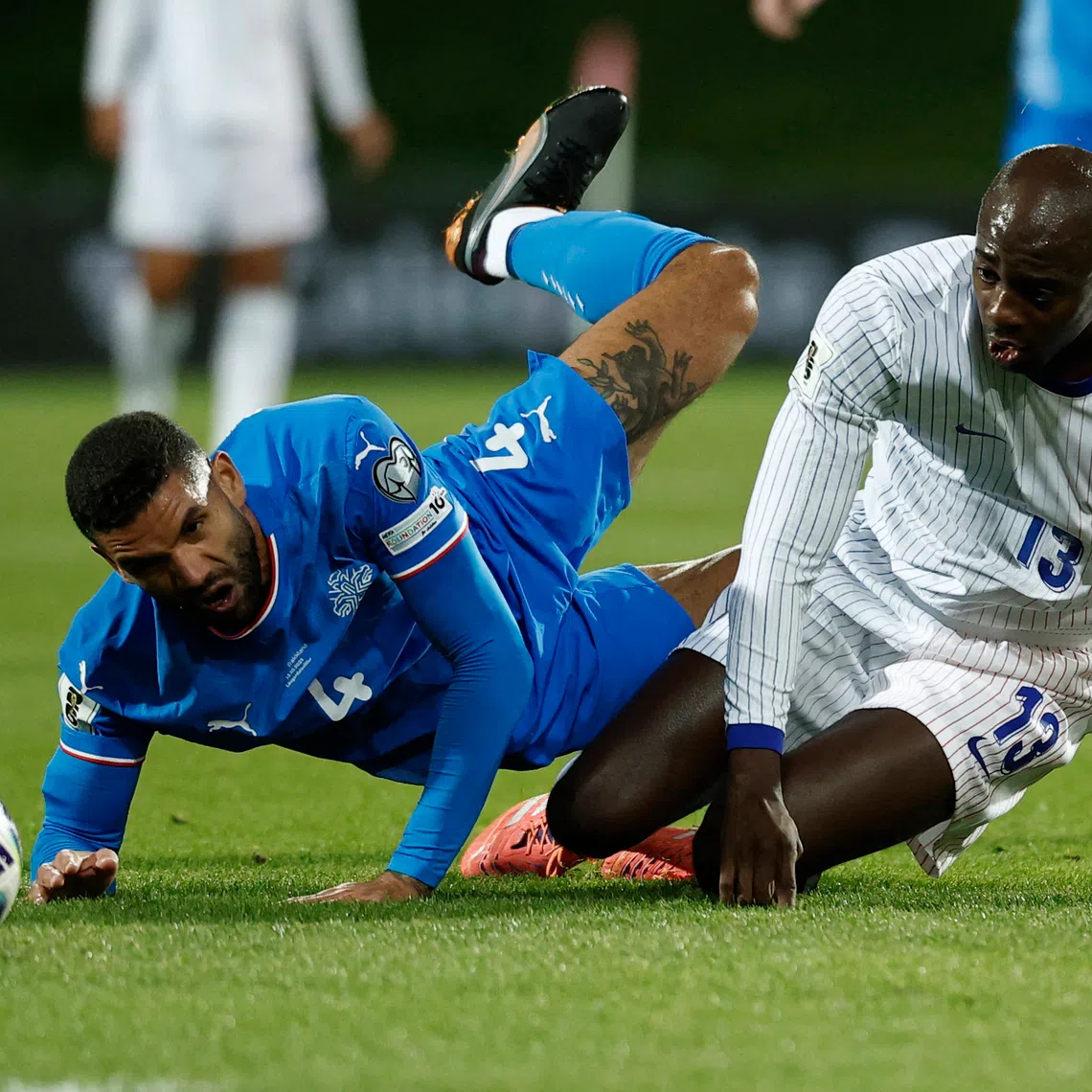 Soccer Football - FIFA World Cup - UEFA Qualifiers - Group D - Iceland v France - Laugardalsvollur, Reykjavik, Iceland - October 13, 2025 Iceland's Victor Palsson in action with France's Jean-Philippe Mateta REUTERS/Benoit Tessier