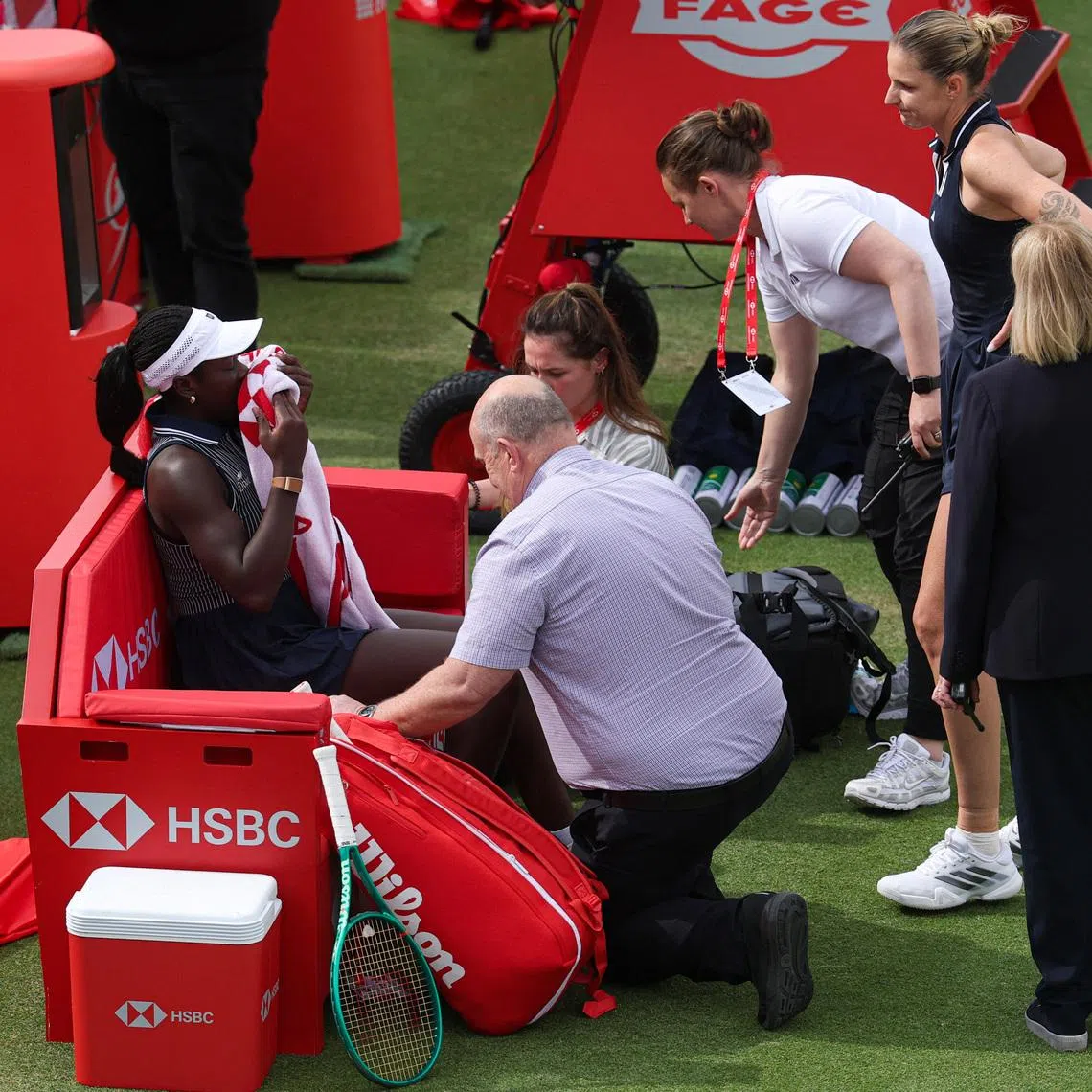 Tennis - Queen's Club Championships - Queen's Club, London, Britain - June 10, 2026  Canada's Victoria Mboko reacts after sustaining an injury and retiring from her round of 16 match as Czech Republic's Karolina Pliskova looks on REUTERS/Toby Melville