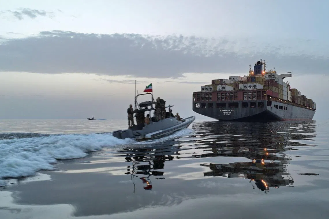 This photo obtained by AFP from the Iranian news agency Tasnim shows an Islamic Revolutionary Guard Corps (IRGC) boat allegedly taking part in an operation to seize ships attempting to cross the Strait of Hormuz, on April 21, 2026. Oil prices had been climbing earlier as investors worried about a lack of progress in ending the Middle East crisis, with Tehran keeping the Strait of Hormuz closed and the US maintaining a blockade of Iranian ports. (Photo by Meysam MIRZADEH / TASNIM NEWS / AFP) / 