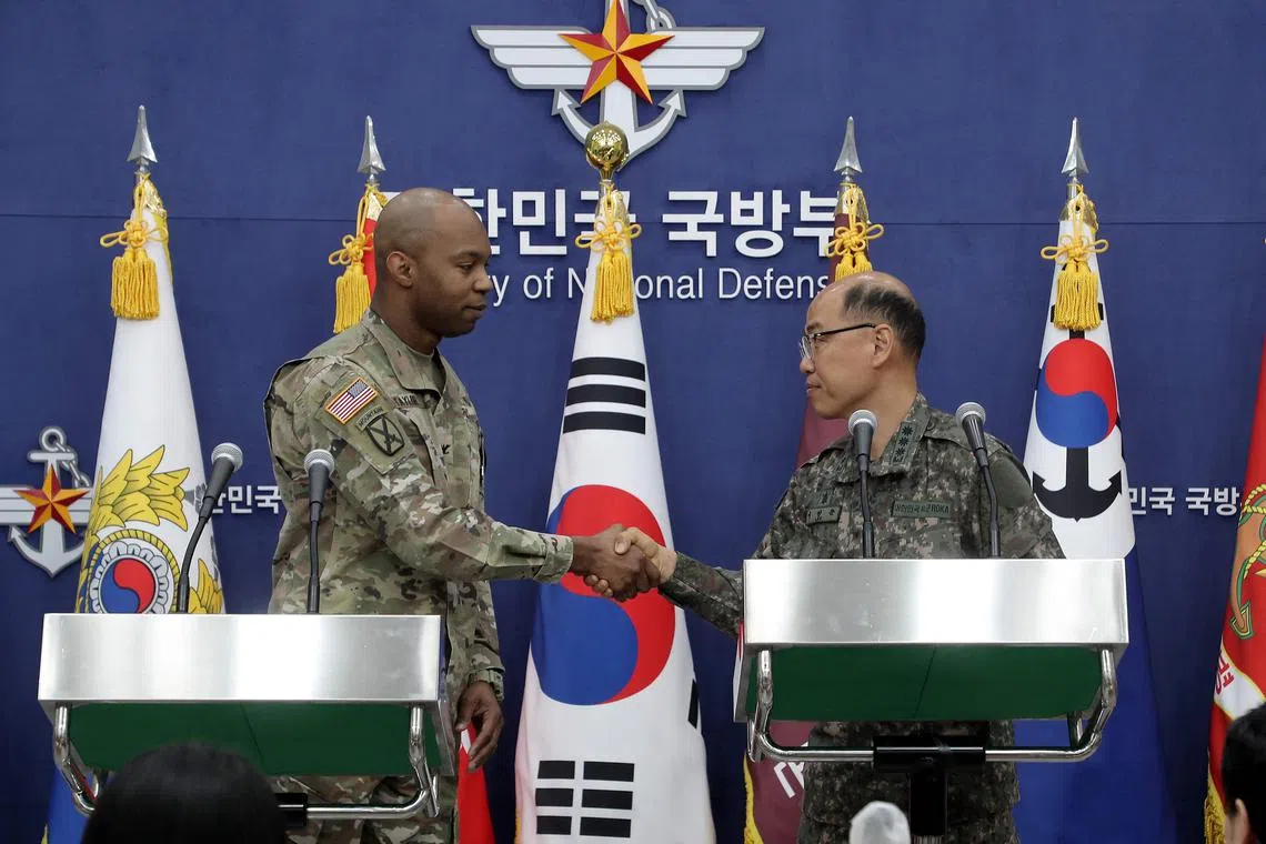 Colonel Isaac Taylor of the UN Command (left) shakes hands with South Korea's Colonel Lee Sung-jun in Seoul on March 3.
