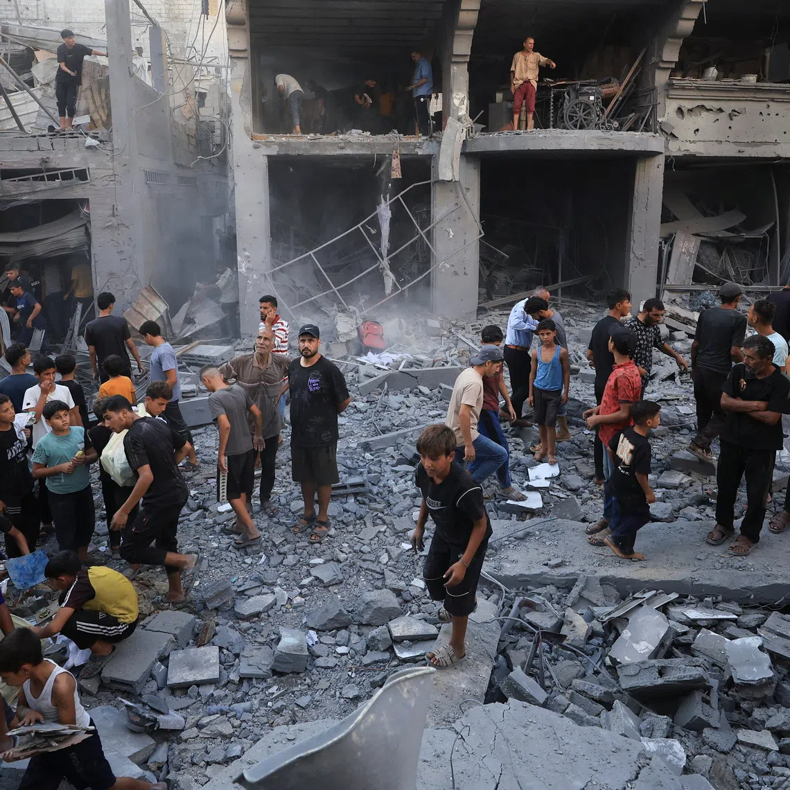Palestinians inspect the site of an Israeli strike on a house, carried out after the Israeli military warned residents to evacuate the area, at al-Shati (Beach) refugee camp, in Gaza City, August 24, 2026. REUTERS/Dawoud Abu Alkas