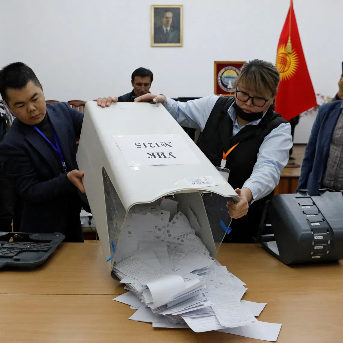 Members of a local electoral commission empty a ballot box to count votes during the snap parliamentary election in Bishkek, Kyrgyzstan November 30, 2025. REUTERS/Vladimir Pirogov
