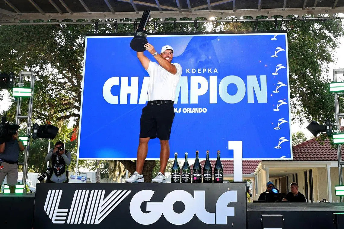 Brooks Koepka celebrating with the trophy after winning the LIV Golf Invitational - Orlando at The Orange County National.   