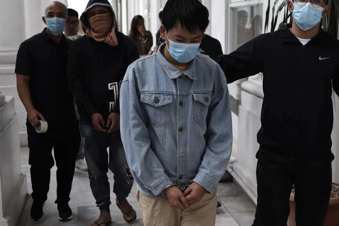 The suspect, identified as Deng Yuanqing (centre), was presented to media on Jan 20.