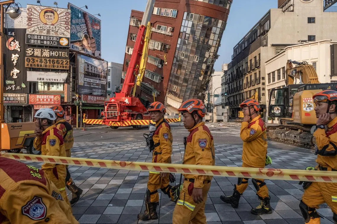 Search and rescue personnel prepare to enter a leaning building following a magnitude-7.4 earthquake in Hualien, Taiwan, on April 3.