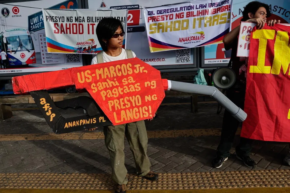 A protester at a rally opposing fuel price hikes and taxes in Quezon City, Metro Manila, on March 19. Patnanungan town's power supply will last from 4pm to 8am daily owing to limited fuel supply.