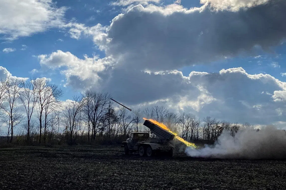 In this file photo, Ukrainian servicemen fire with a BM21 Grad multiple launch rocket system in a frontline on the border of Kharkiv and Luhansk regions, as Russia's attack on Ukraine continues. 