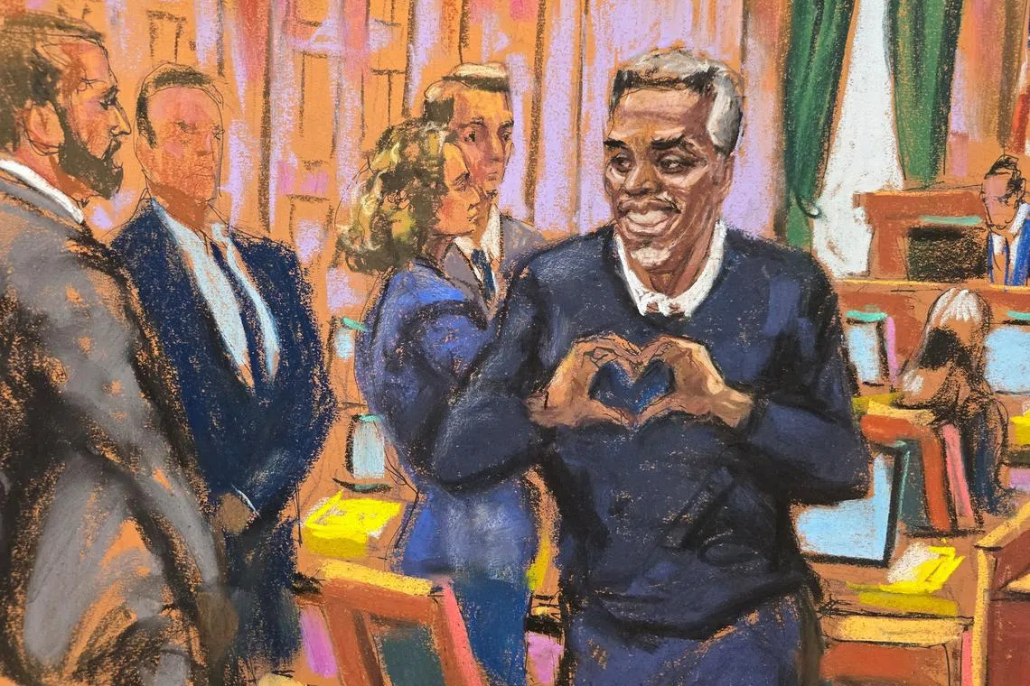 Sean "Diddy" Combs making a heart gesture as he enters the courtroom for his sex trafficking trial in New York City, on May 28.