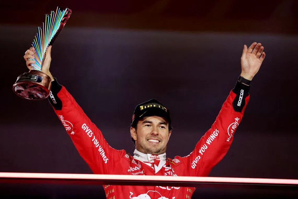 Formula One F1 - Las Vegas Grand Prix - Las Vegas Strip Circuit, Las Vegas, Nevada, U.S - November 18, 2023 Third place Red Bull's Sergio Perez celebrates with his trophy on the podium REUTERS/Mike Blake