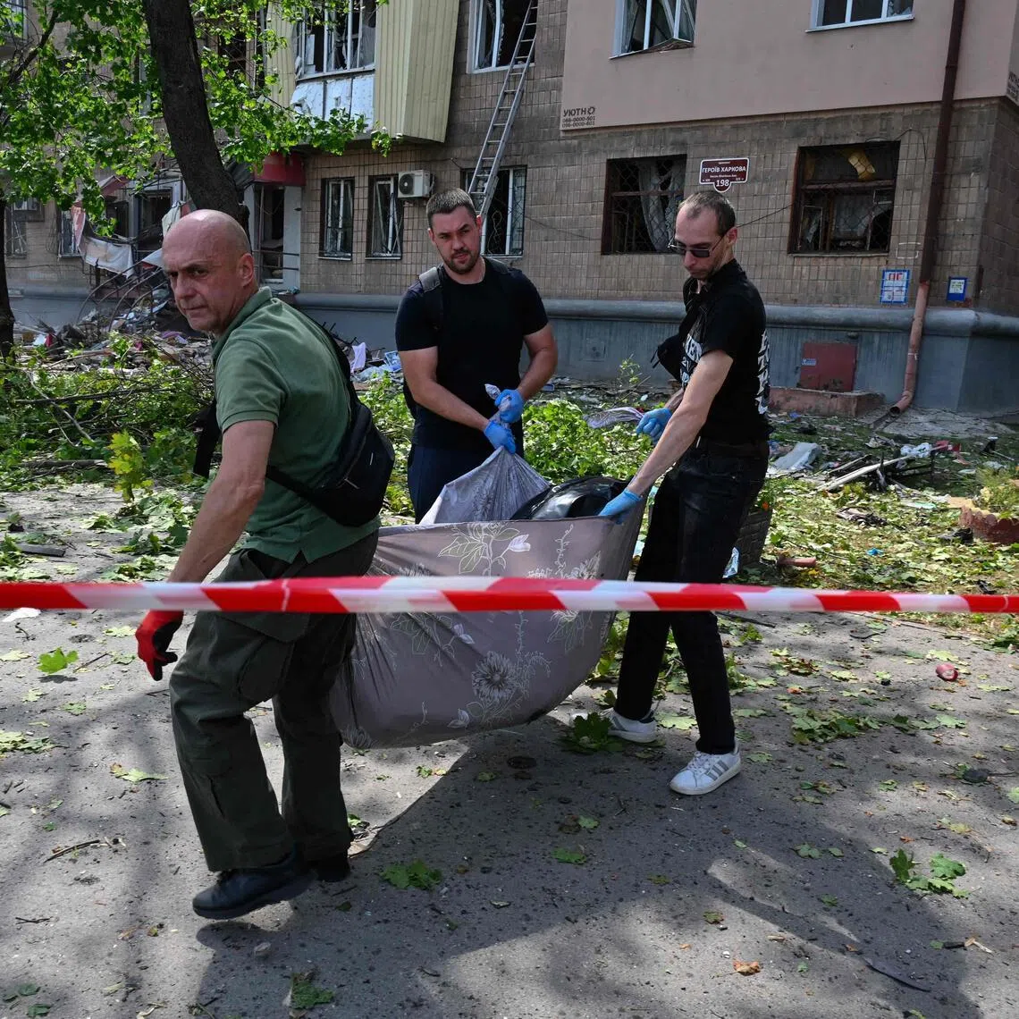 The body of a local resident is removed from the site of a Russian missile attack in Kharkiv, Ukraine, on July 8.