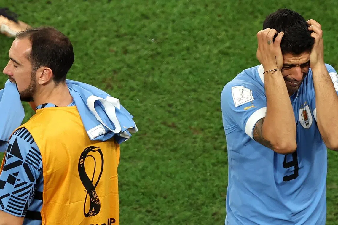 Luis Suarez (right) and Diego Godin reacting as Uruguay bow out of the World Cup despite their 2-0 win over Ghana on Friday. 