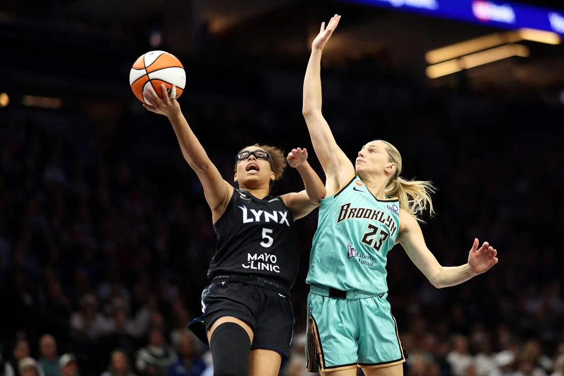 MINNEAPOLIS, MINNESOTA - SEPTEMBER 18: Olivia Miles #5 of the Minnesota Lynx draws a foul against Marine Johannes #23 of the New York Liberty in the fourth quarter at Target Center on September 18, 2026 in Minneapolis, Minnesota. The Liberty defeated the Lynx 93-81. NOTE TO USER: User expressly acknowledges and agrees that, by downloading and or using this photograph, User is consenting to the terms and conditions of the Getty Images License Agreement.   David Berding/Getty Images/AFP (Photo by David Berding / GETTY IMAGES NORTH AMERICA / Getty Images via AFP)