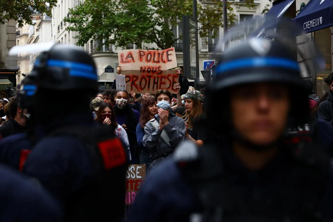 French riot police in position on Oct 7, as students block the street outside Sciences Po university in Paris as part of nationwide protests demanding better high school conditions.