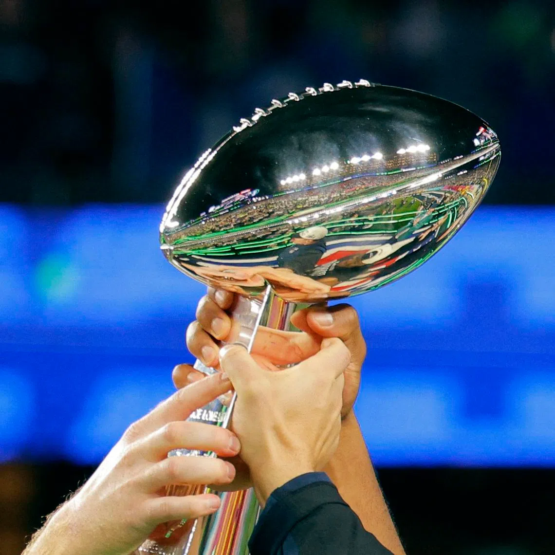 Football - NFL - Super Bowl LX - New England Patriots v Seattle Seahawks - Levi's Stadium, Santa Clara, California, United States - February 8, 2026 Seattle Seahawks players hold aloft the Vince Lombardi Trophy as they celebrate after winning Super Bowl LX REUTERS/Mike Blake