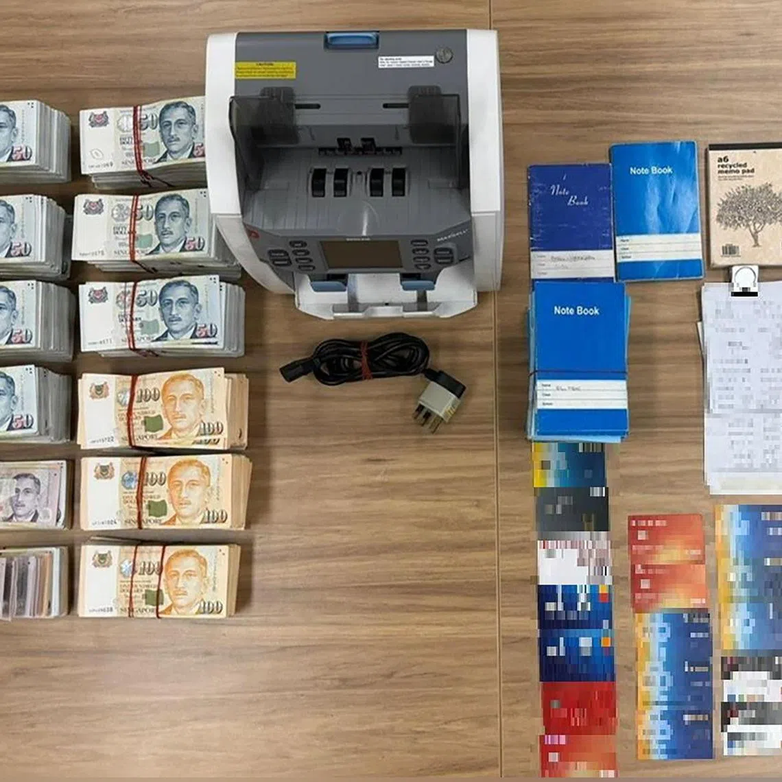 More than $314,000 in cash and 30 ATM cards were seized, among other items, during a raid of the operations.