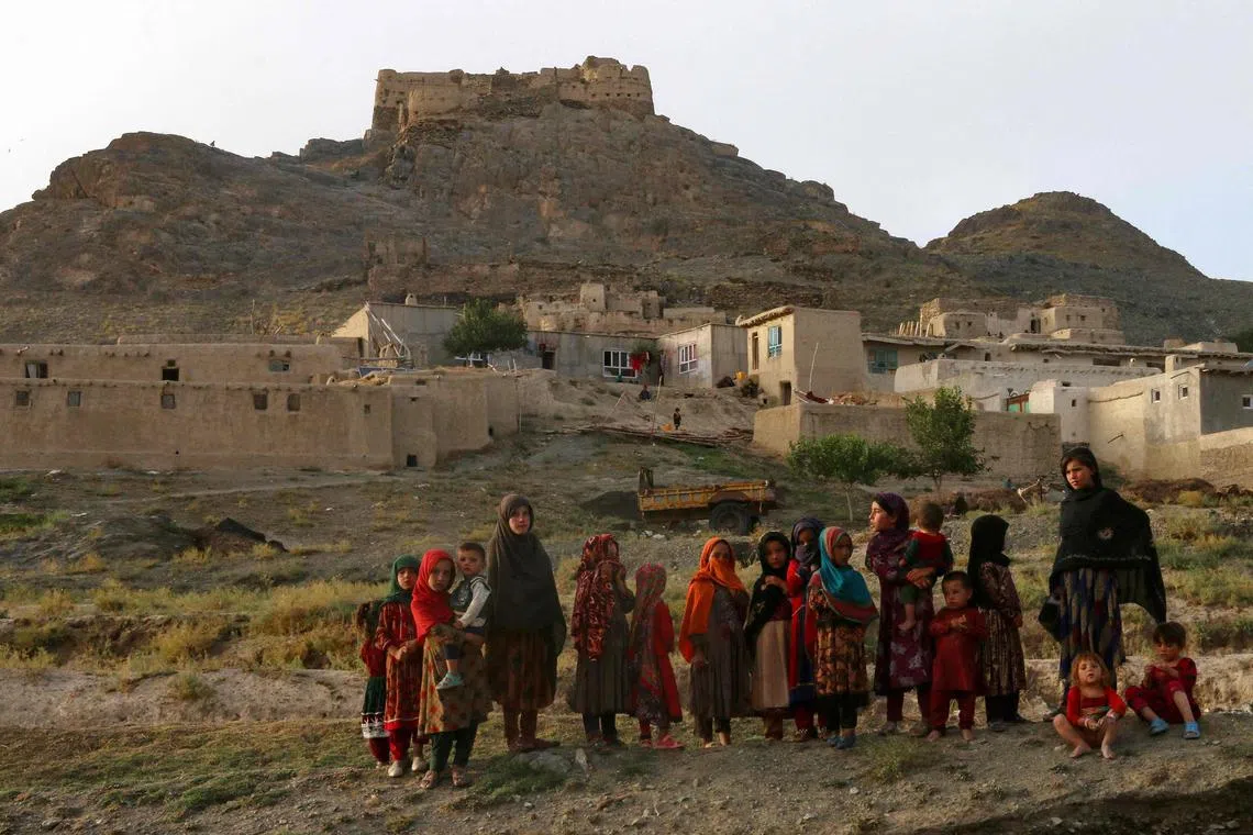 Afghan girls gather near their house at the Shir Buz area in Deh Yak district, Ghazni province on August 19, 2024. (Photo by MOHAMMAD FAISAL NAWEED / AFP)