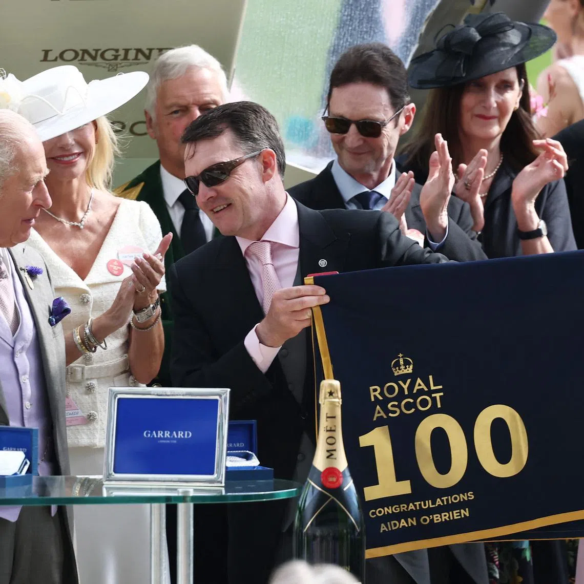 Horse Racing - Royal Ascot 2026 - Ascot Racecourse, Ascot, Britain - June 18, 2026 Aidan O'Brien, trainer of Scandinavia is presented with a racing tack to commemorate 100 Ascot race wins by Britain's King Charles after winning the 16.15 Gold Cup REUTERS/Toby Melville