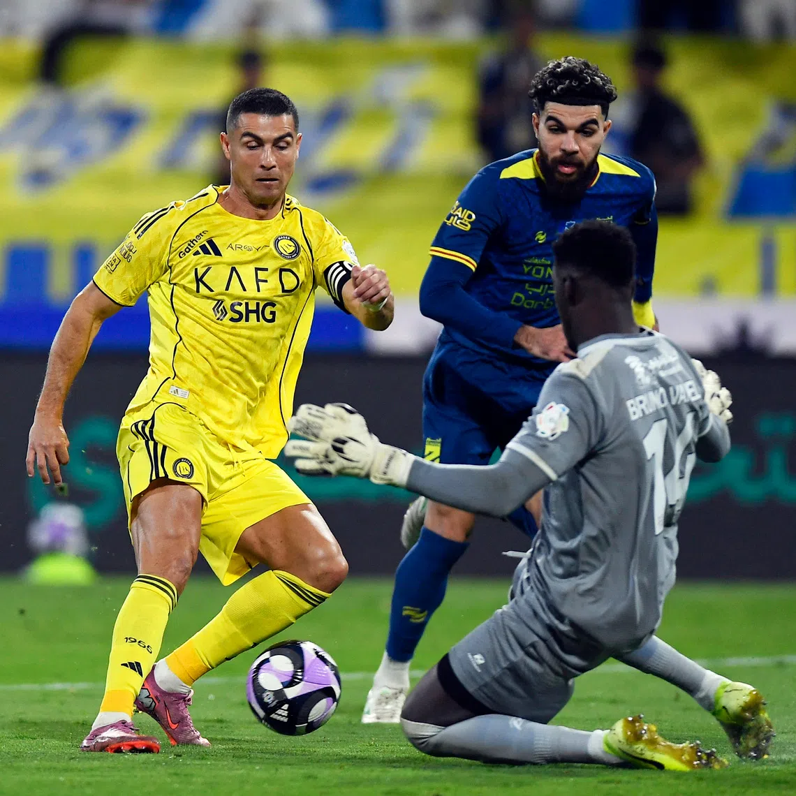 Soccer Football - Saudi Pro League - Al Hazem v Al Nassr - King Abdullah Sport City Stadium, Buraydah, Saudi Arabia - October 25, 2025 Al Nassr's Cristiano Ronaldo in action with Al Hazem's Bruno Varela REUTERS/Stringer