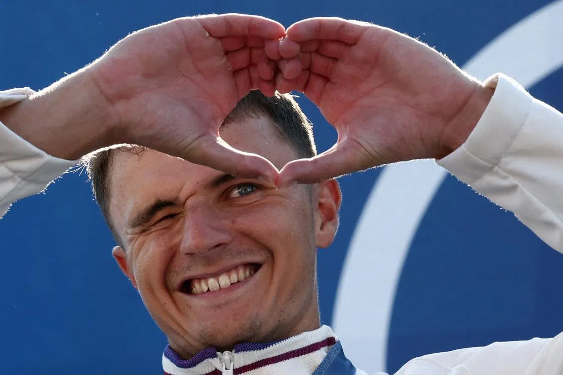 Paris 2024 Olympics - Slalom Canoe - Men's Canoe Single Victory Ceremony - Vaires-sur-Marne Nautical Stadium - Whitewater, Vaires-sur-Marne, France - July 29, 2024. Gold medallist Nicolas Gestin of France gestures, as he celebrates on the podium after winning. REUTERS/Yara Nardi