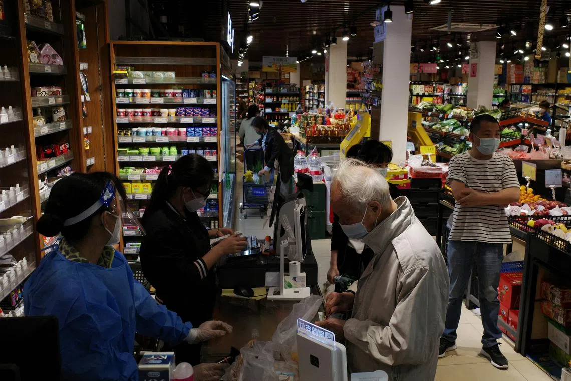 People shopping at a supermarket in Guangzhou on Nov 30, 2022. China could play a crucial role in global growth in 2023.