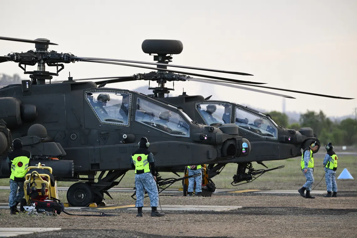 RSAF personnel conducting preflight checks on AH-64D Apache attack helicopters at Warriors Den in the Shoalwater Bay Training Area in Queensland, Australia on Oct 21.