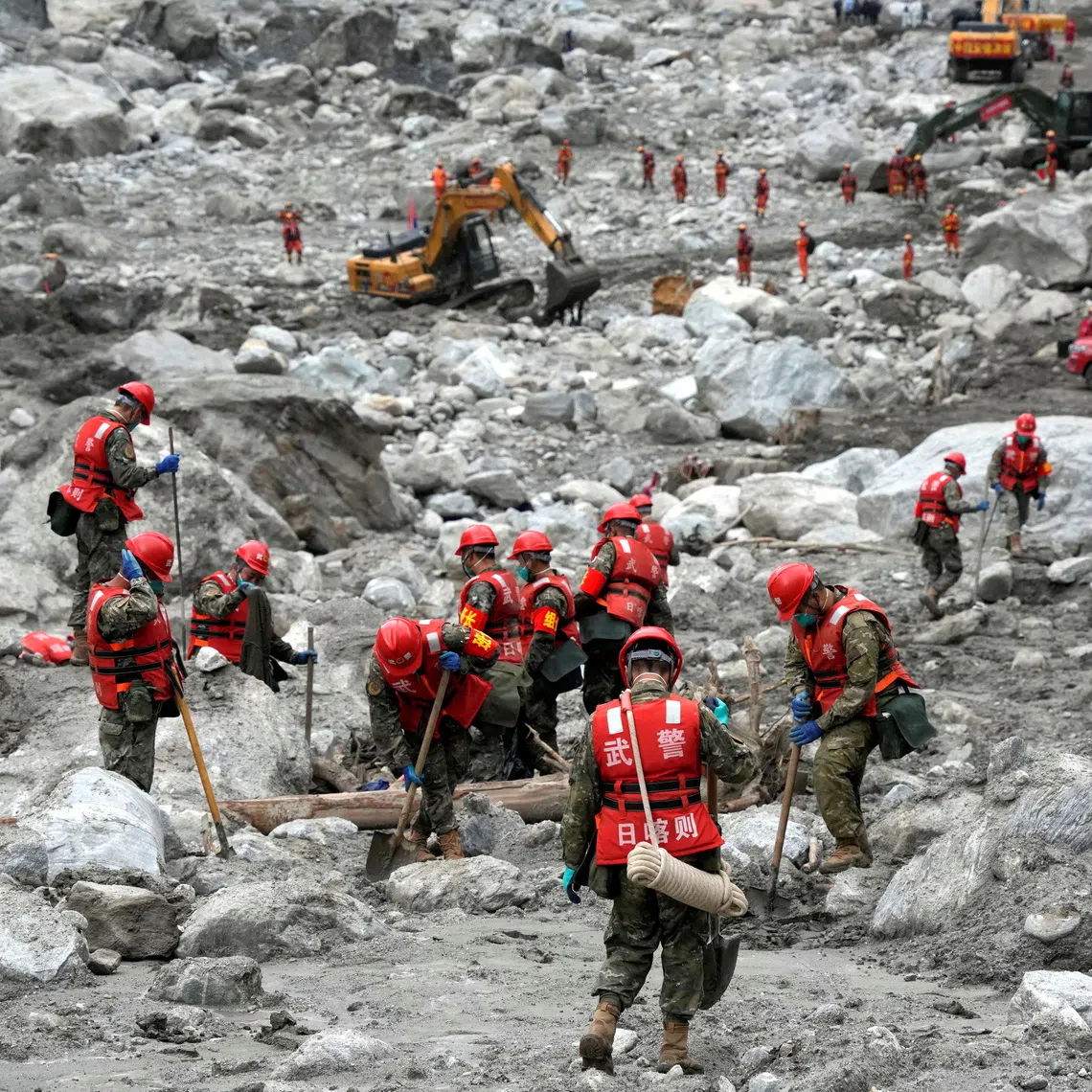 Rescue workers conduct search-and-rescue operations at the Gyirong border crossing separating China’s Tibet and Nepal.