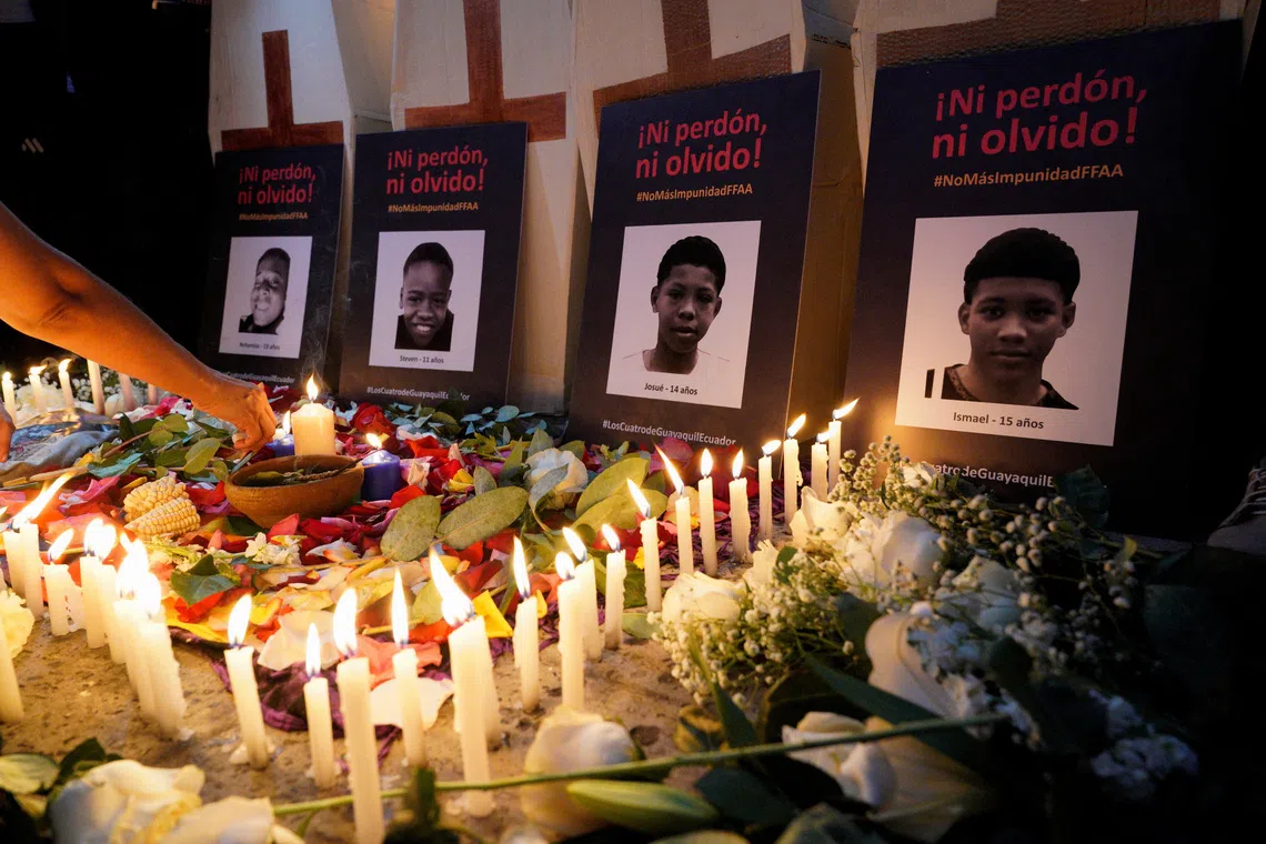 Signs reading \"Neither forgiveness nor forgetting\" with pictures of four boys who disappeared and were later found dead, are displayed during a vigil on the one-year anniversary of their disappearance, in the Las Malvinas neighbourhood in Guayaquil, Ecuador, December 8, 2025. REUTERS/Santiago Arcos