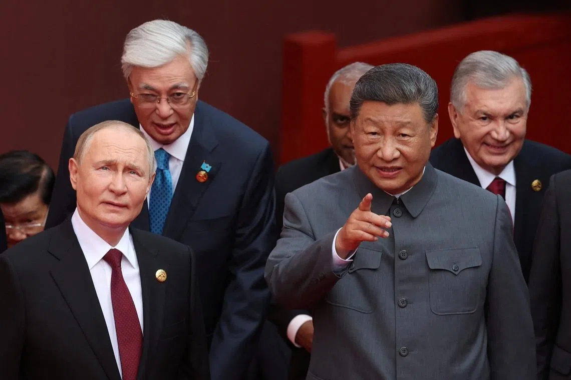 The exchange between Chinese President Xi Jinping (right) and Russian President Vladimir Putin were widely shared by broadcasters and on social media globally.