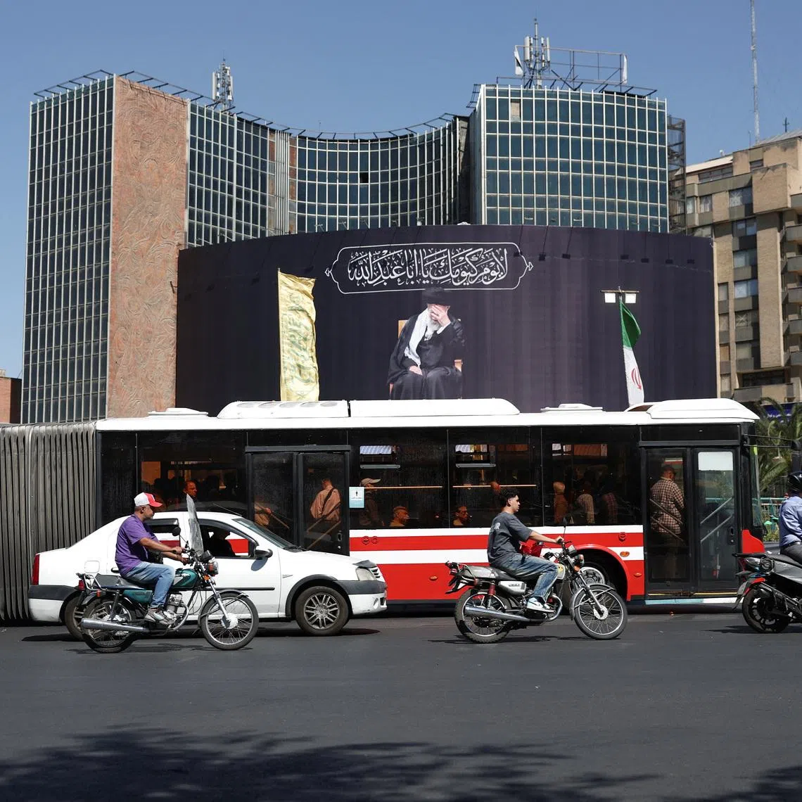 People drive past a billboard with a picture of the late Iran's Supreme Leader Ayatollah Ali Khamenei, after U.S. and Iranian officials said they had reached a deal to end their war and reopen the Strait of Hormuz, in Tehran, Iran, June 15, 2026. Majid Asgaripour/WANA (West Asia News Agency) via REUTERS