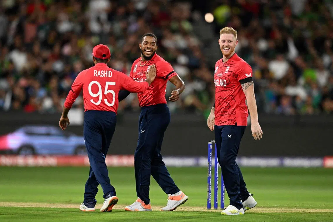 England's Ben Stokes (right), Chris Jordan (centre) and Adil Rashid celebrates after the dismissal of Pakistan's Shadab Khan during the Twenty20 World Cup 2022 final match at The Melbourne Cricket Ground on Nov 13, 2022.