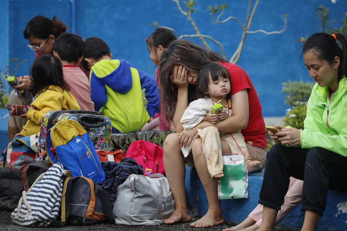 Survivors of the landslide resting at police station after being rescued.