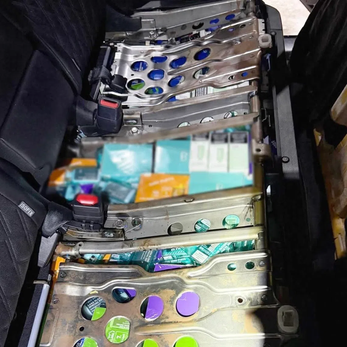 Photos posted on ICA’s Facebook page show e-vaporisers and related components hidden in the car’s boot as well as under the rear seats.