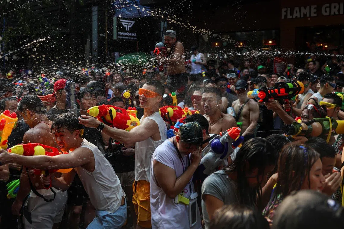 Locals and tourists play with water as they celebrate the Songkran holiday which marks the Thai New Year in Bangkok, Thailand, April 13, 2024. REUTERS/Chalinee Thirasupa