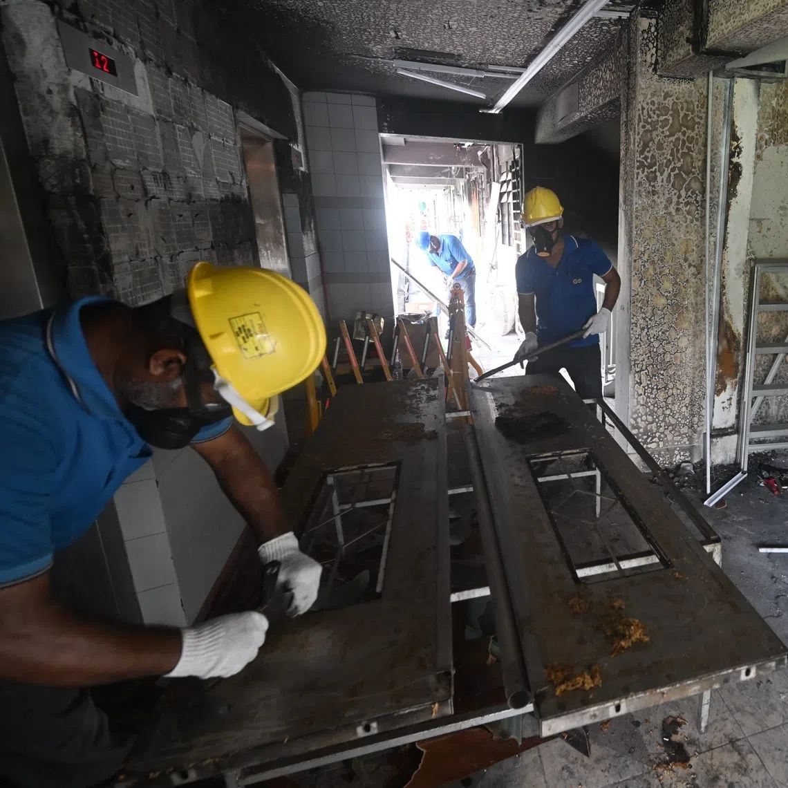 Workers doing repair works after the fire at 510 Ang Mo Kio Avenue 8, seen on Sept 26.