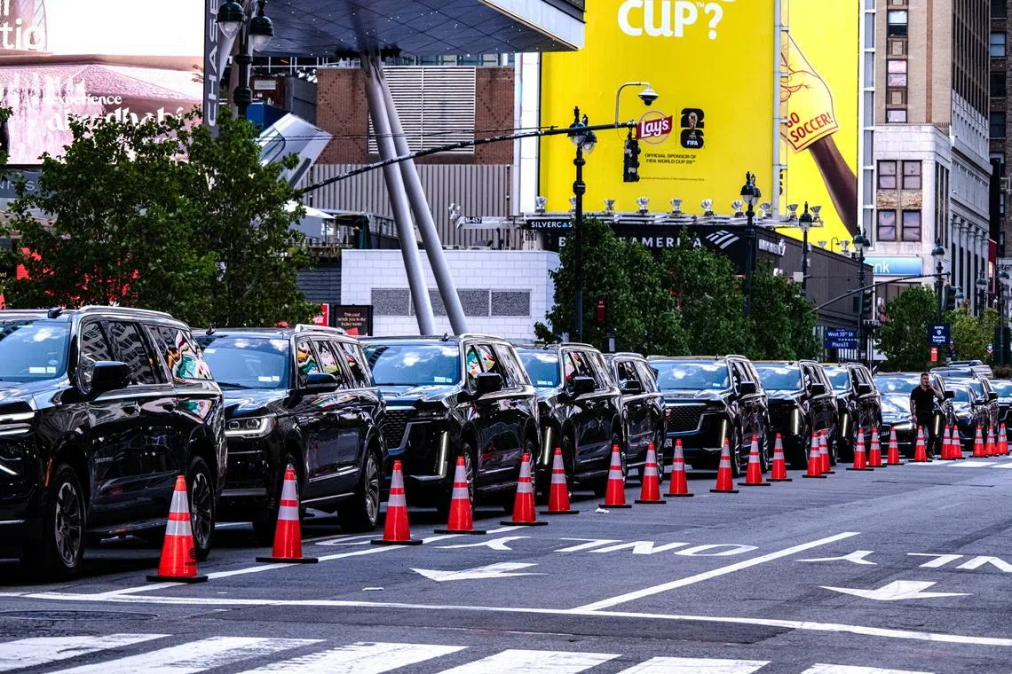 A long line of black SUVs waits to pass through several layers of security on July 3.