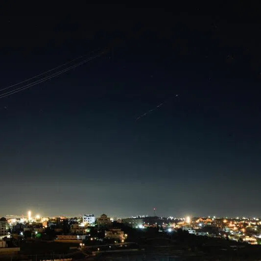 Iranian missiles fly in the sky over Israel on June 7, as seen from Hebron, in the Israeli-occupied West Bank.